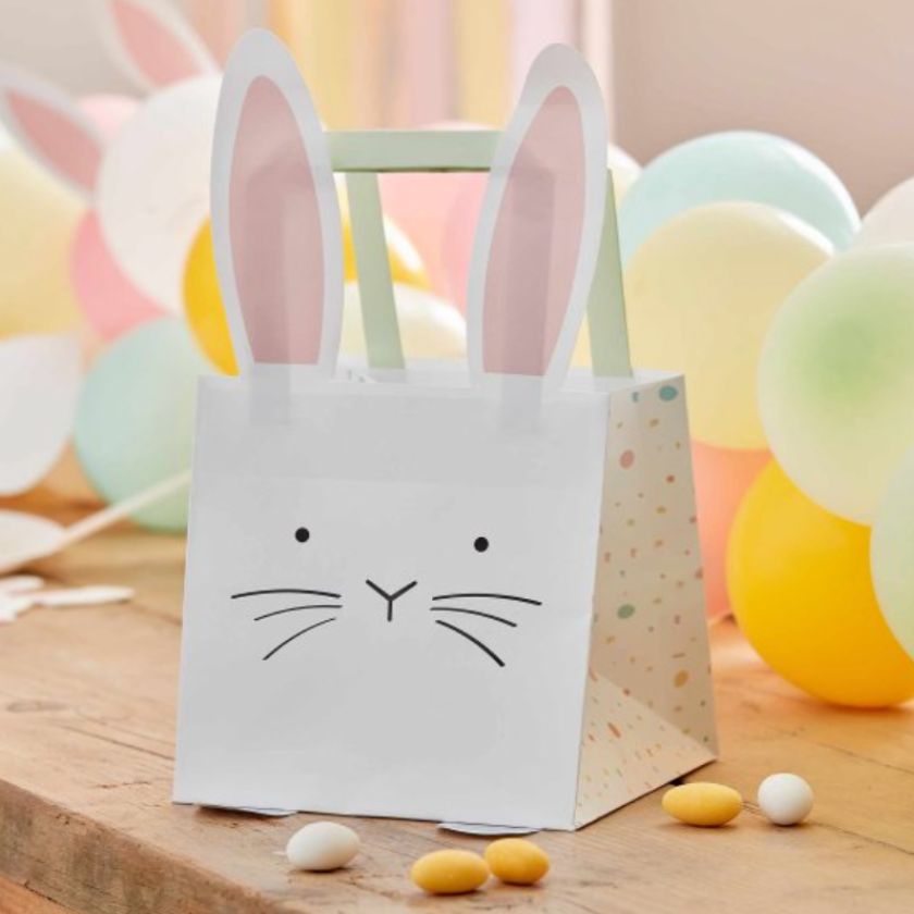 Beautiful easter table with party bags, easter eggs and balloon tablerunner