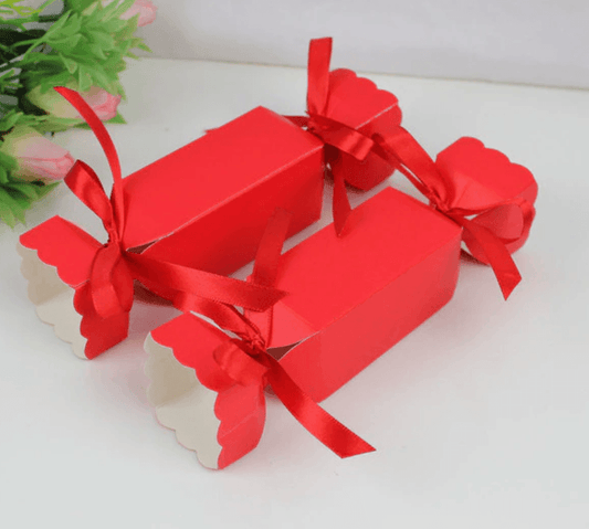 Beautiful bright red bon bons with red ribbon on both ends