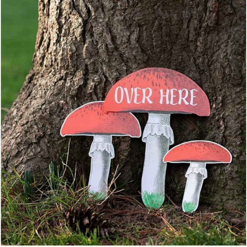 Super fun Alice in Wonderland toadstool signposts with the words over here to use in treasure hunt or decoration.