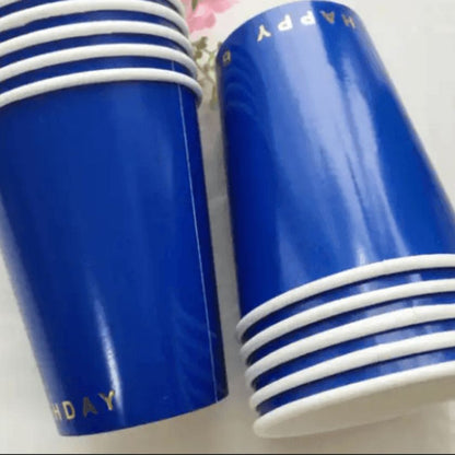 Classic happy birthday party cups in dark blue and gold writing on bottom