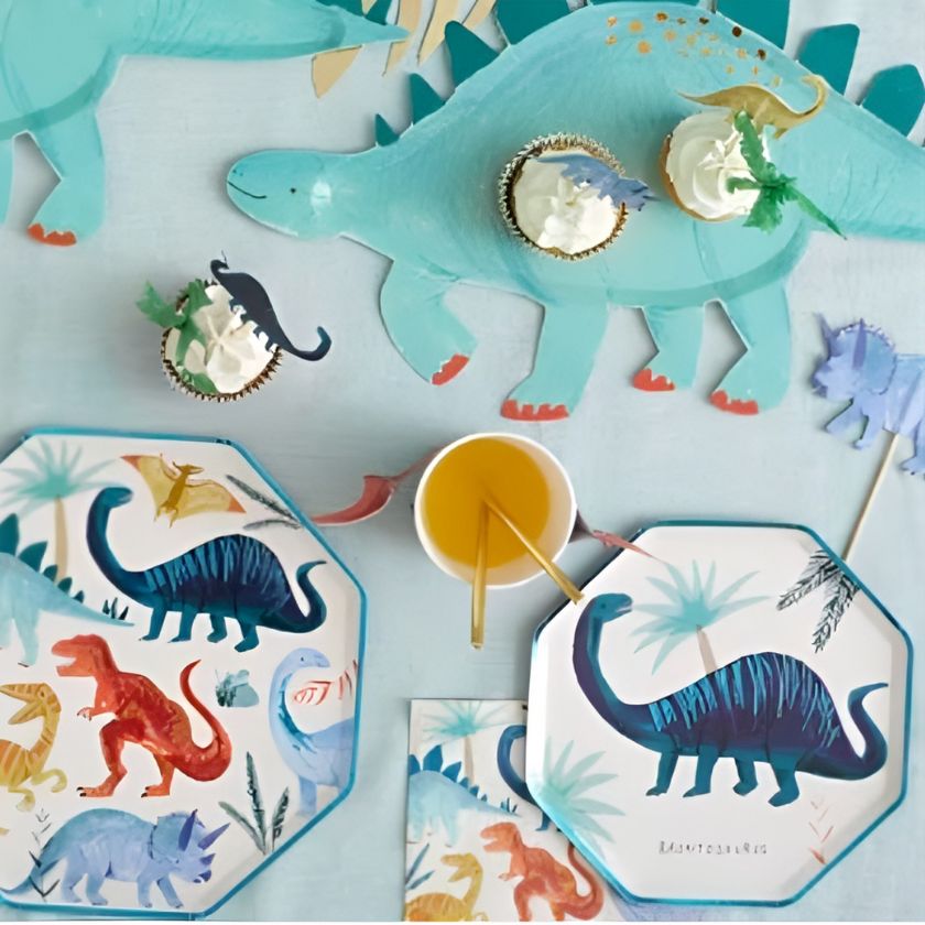 Awesome Dinosaur plates on table with cups, napkins and dinosaur platter