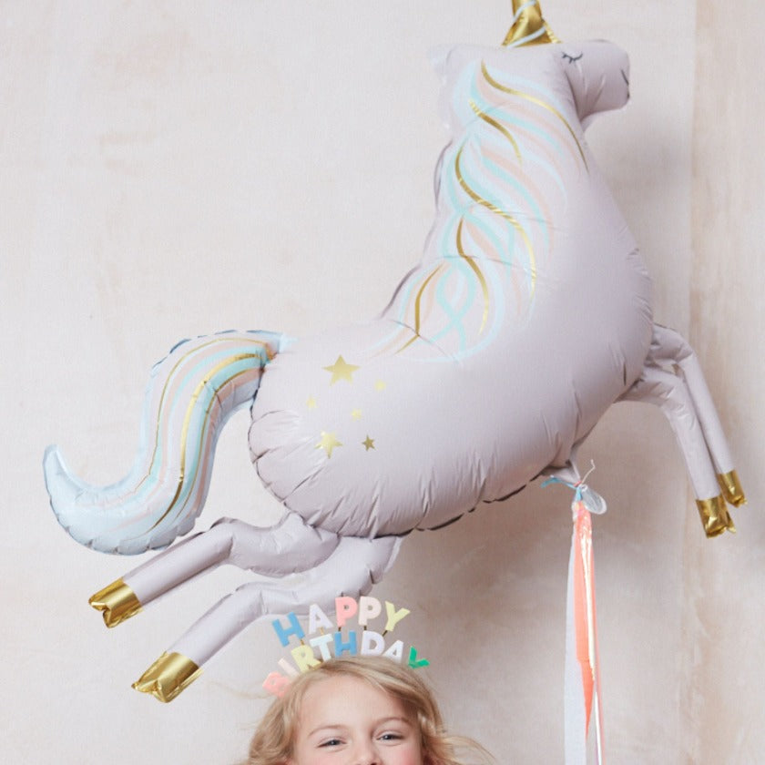 Stunning Photo of little girl with our Jumbo sized Unicorn Balloon With streamers. 107cm