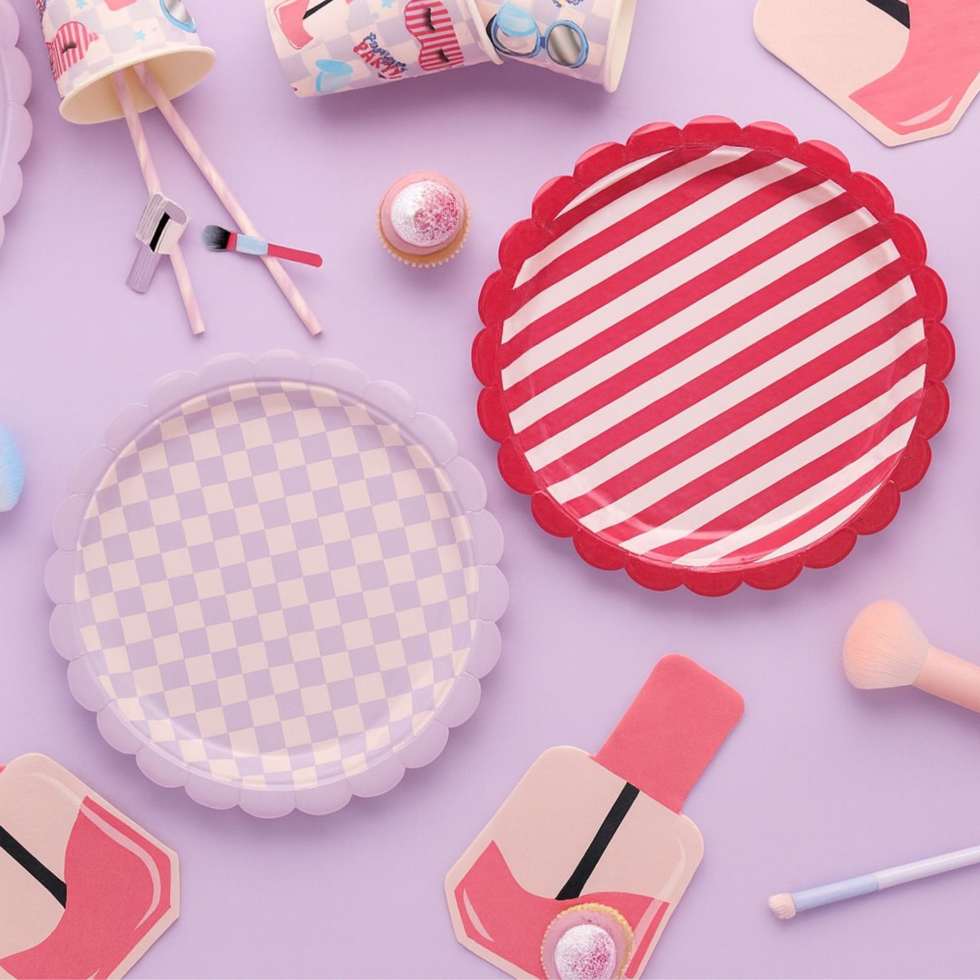 Colourful scalloped edge paper plates in lilac checkerboard and cherry red striped designs