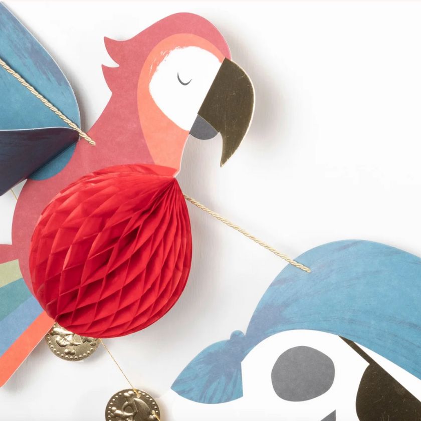 Close up of Meri-Meri's Pirate Icon Garland featuring blue skull and red parrot 