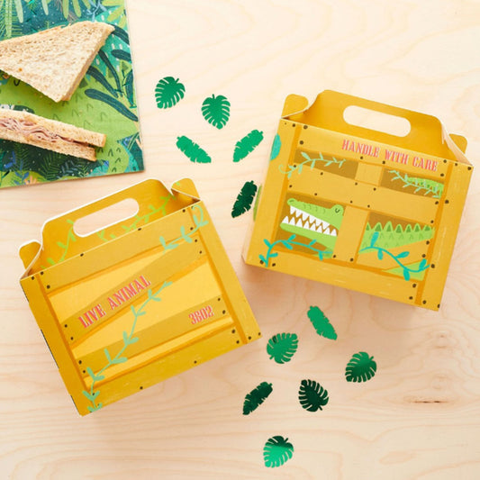 Yellow crates with crocodile designs on a wooden surface with green leaf decorations.