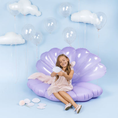 Child sitting on a purple shell-shaped inflatable chair with seashell invitation