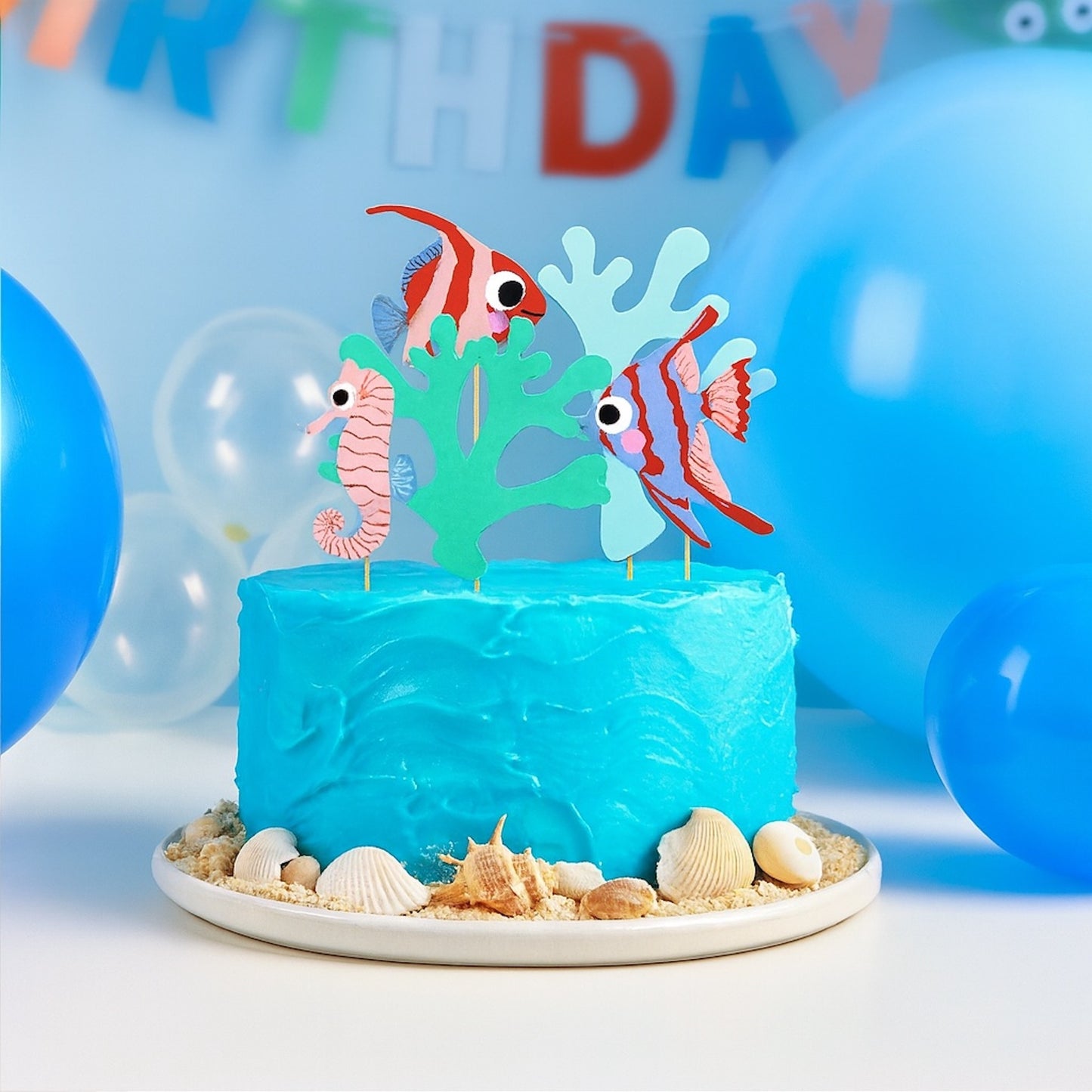 Cake topper set with 5 ocean-themed decorations including fish & coral. 