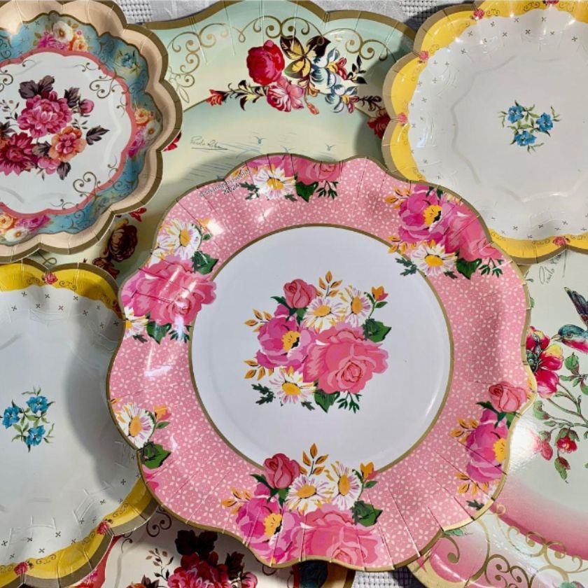 Beautiful vintag style plates staced on top of each other in pink multi colours