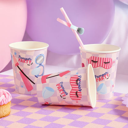 Paper cups with cosmetic-themed design on a checkered tablecloth