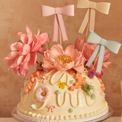 Beautiful bow cake toppers on floral cake 