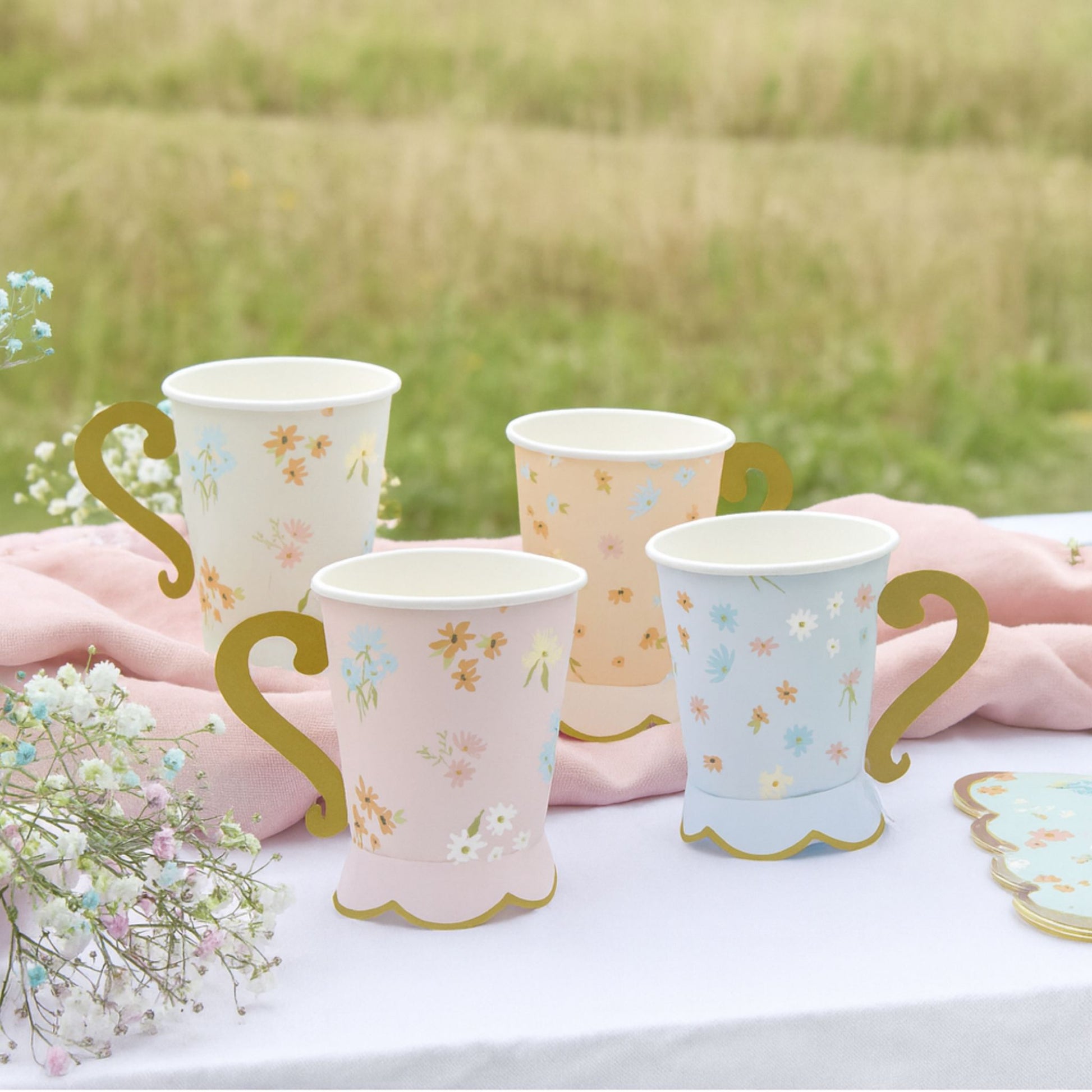 Adorable floral pastel cups with gold handles.