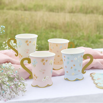 Adorable floral pastel cups with gold handles.