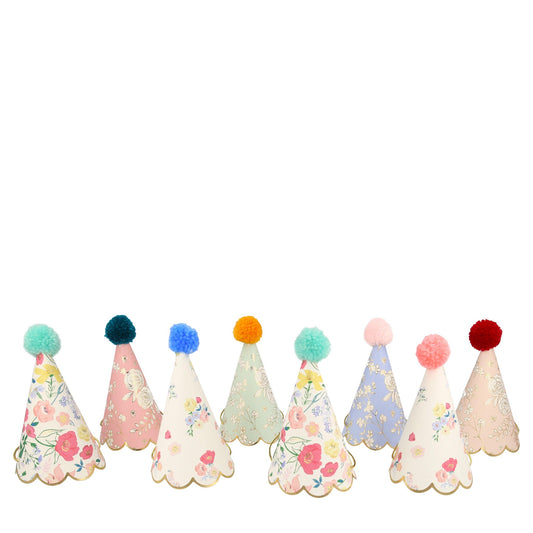 Meri meri party hats in an english garden floral design in different colours and topped with pom poms in a variety of colours